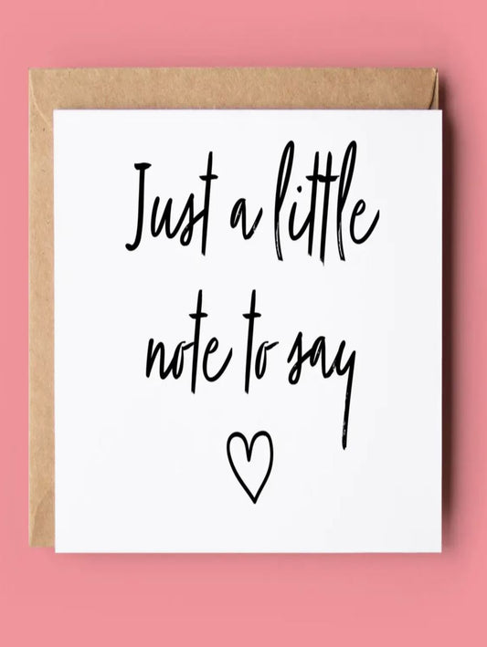 This is  a white card with letters in black that read 'just a little note to say'