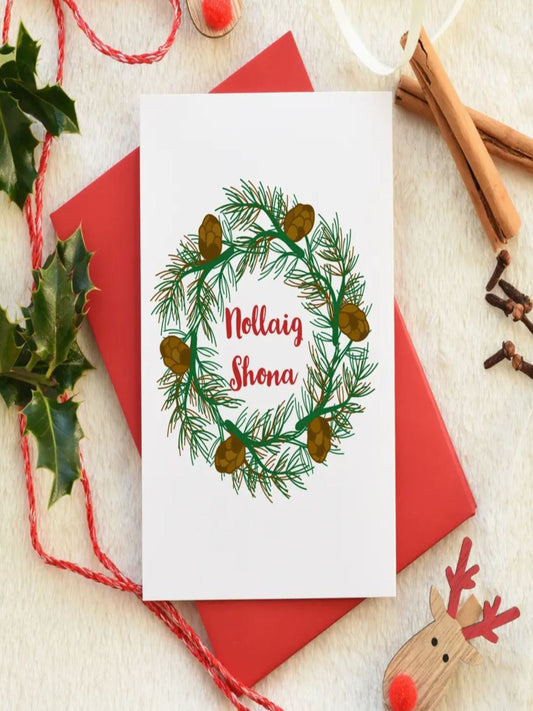 This card is a drawing of a wreath and in the middle is says 'NOLLAIG SHONA' which is the Irish for Happy Christmas. The writing is in red and the wreath is in green. There's also a red envelope.