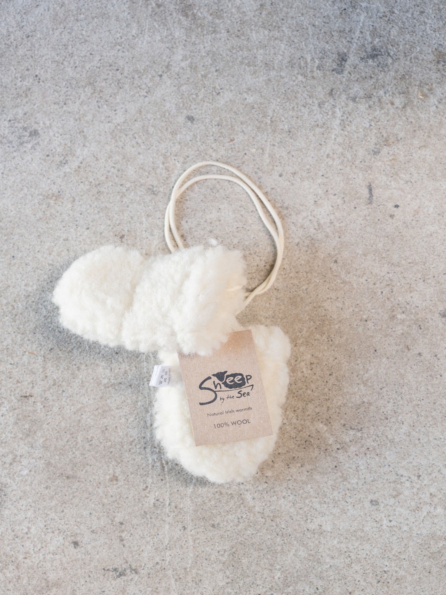 Pair of white sheepskin mittens made in Ireland by Sheep by the sea. These are 100% wool and made in Ireland. Perfect baby gift.