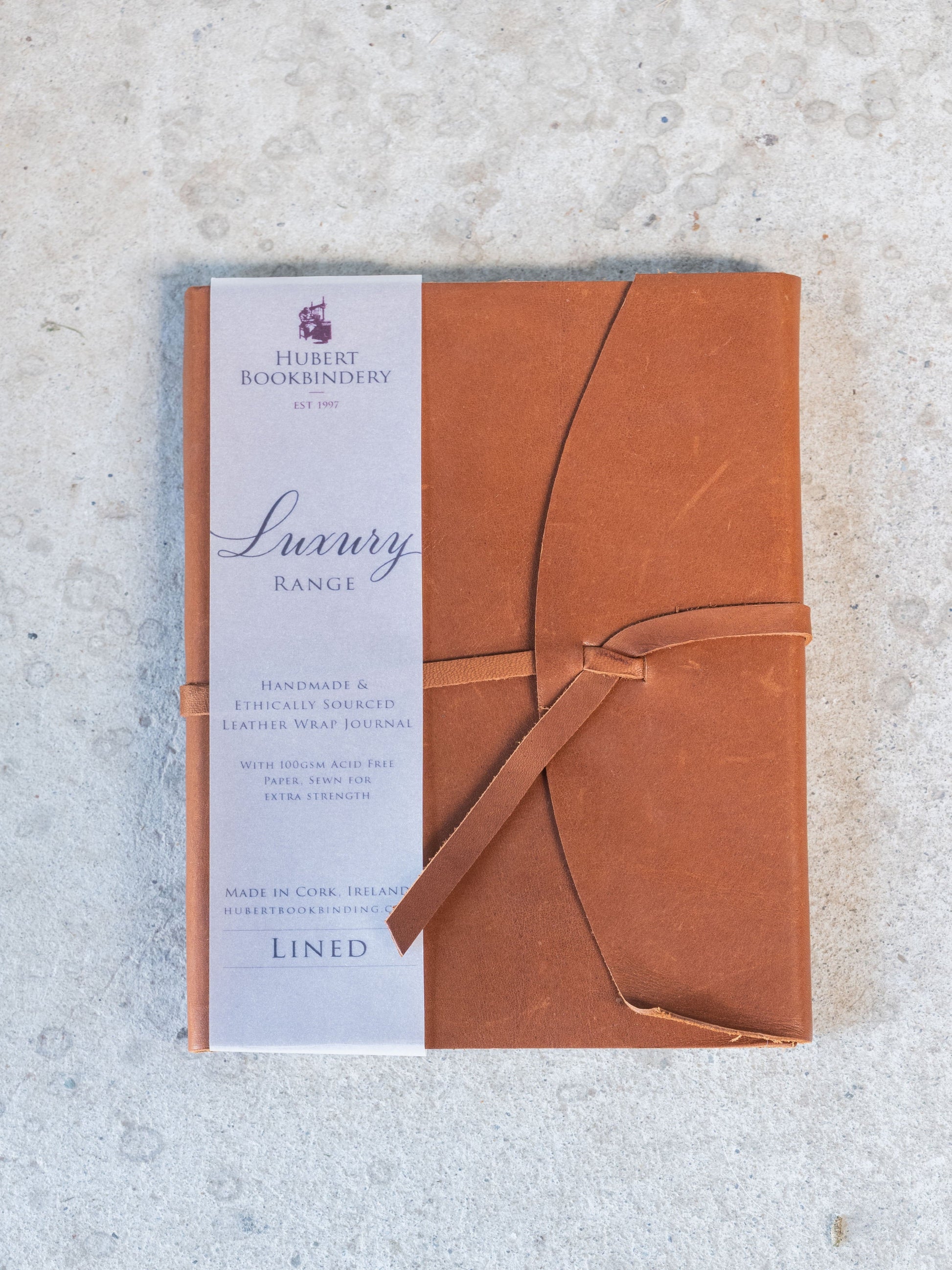 Brown leather-bound book with a label on a textured surface