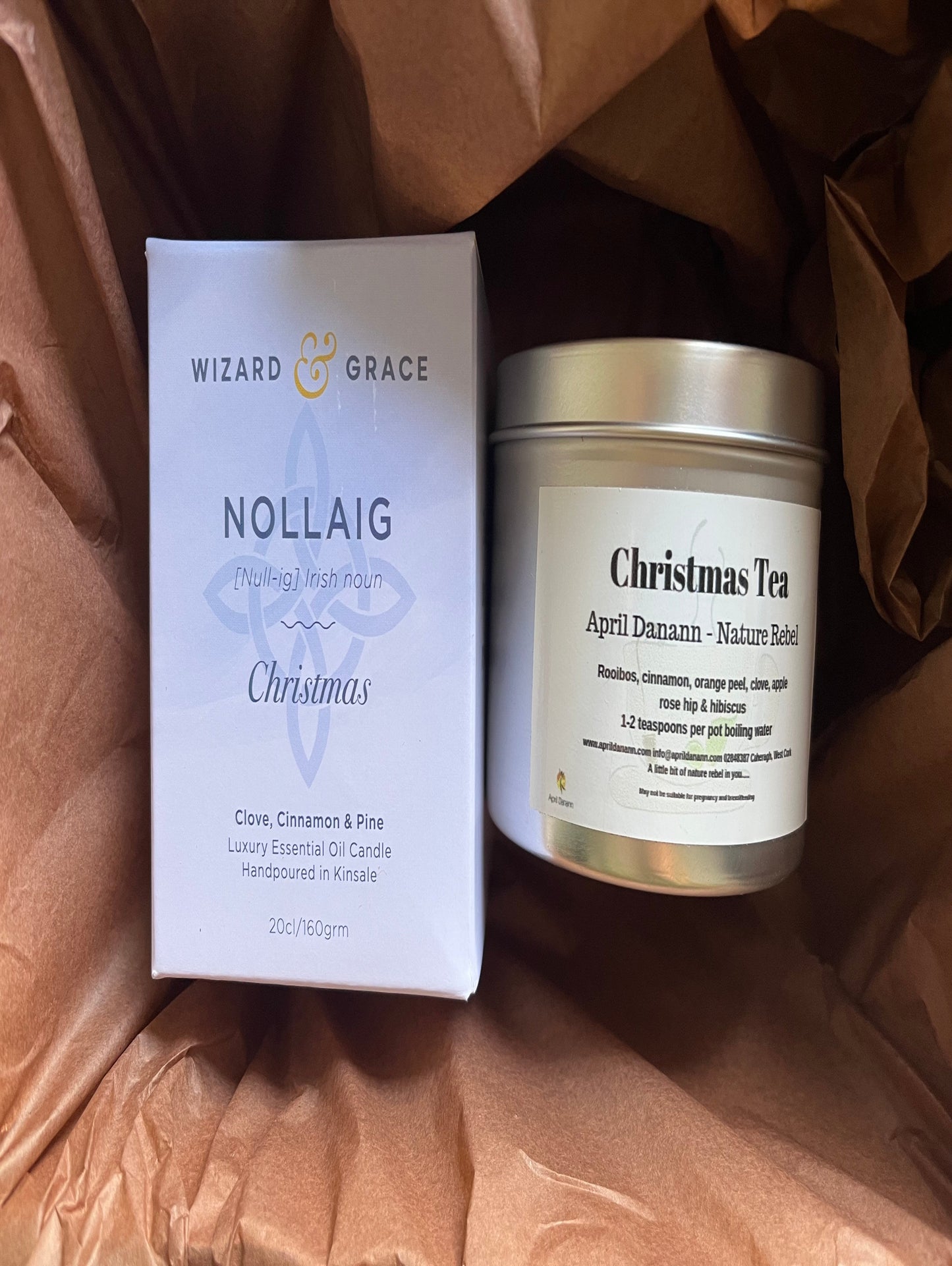 Candle and packaging with 'Wizard & Grace' branding on a brown textured background