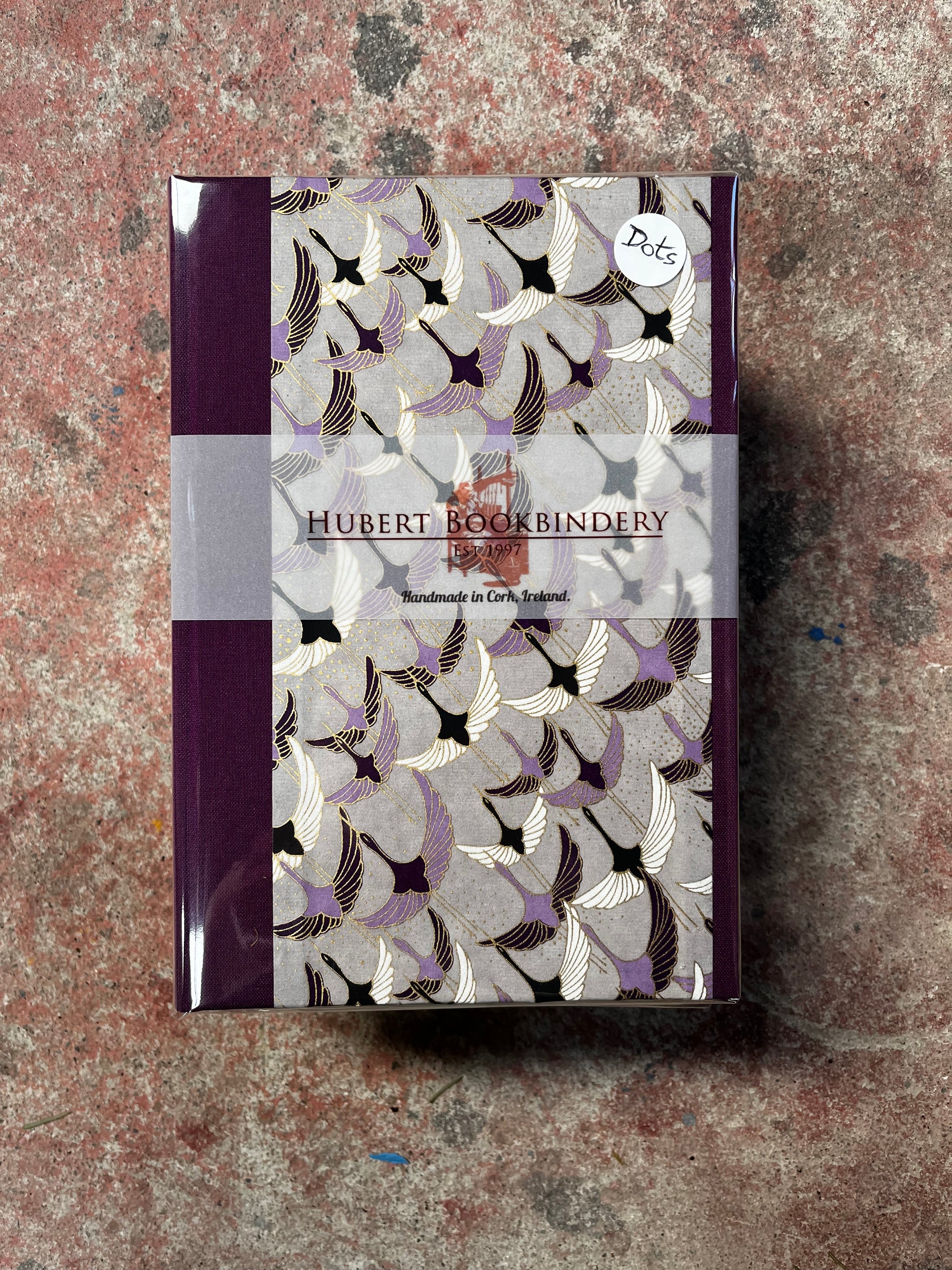 Book with decorative cover featuring geometric patterns on a textured surface
