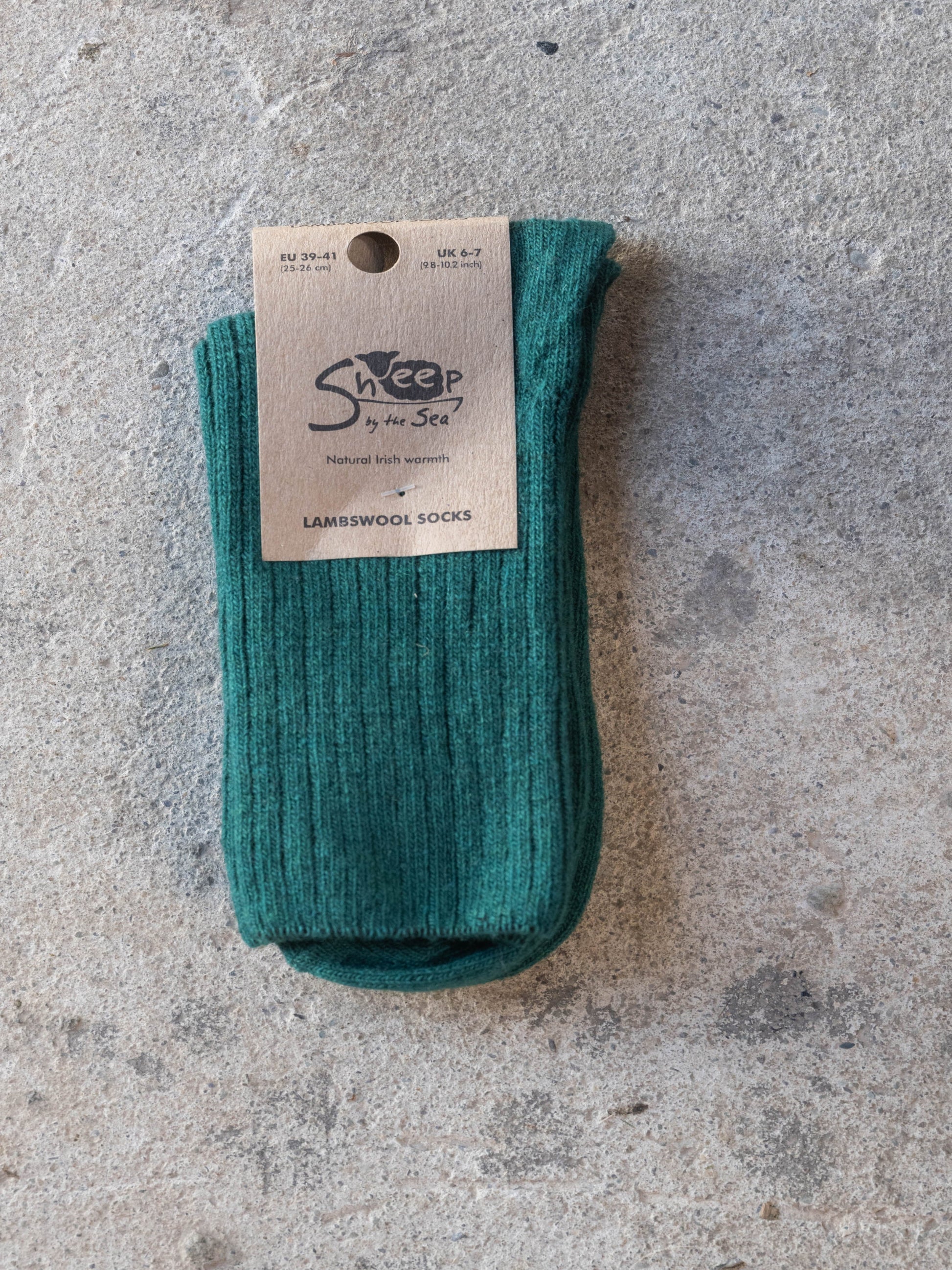 Green sock with a label on a gray surface