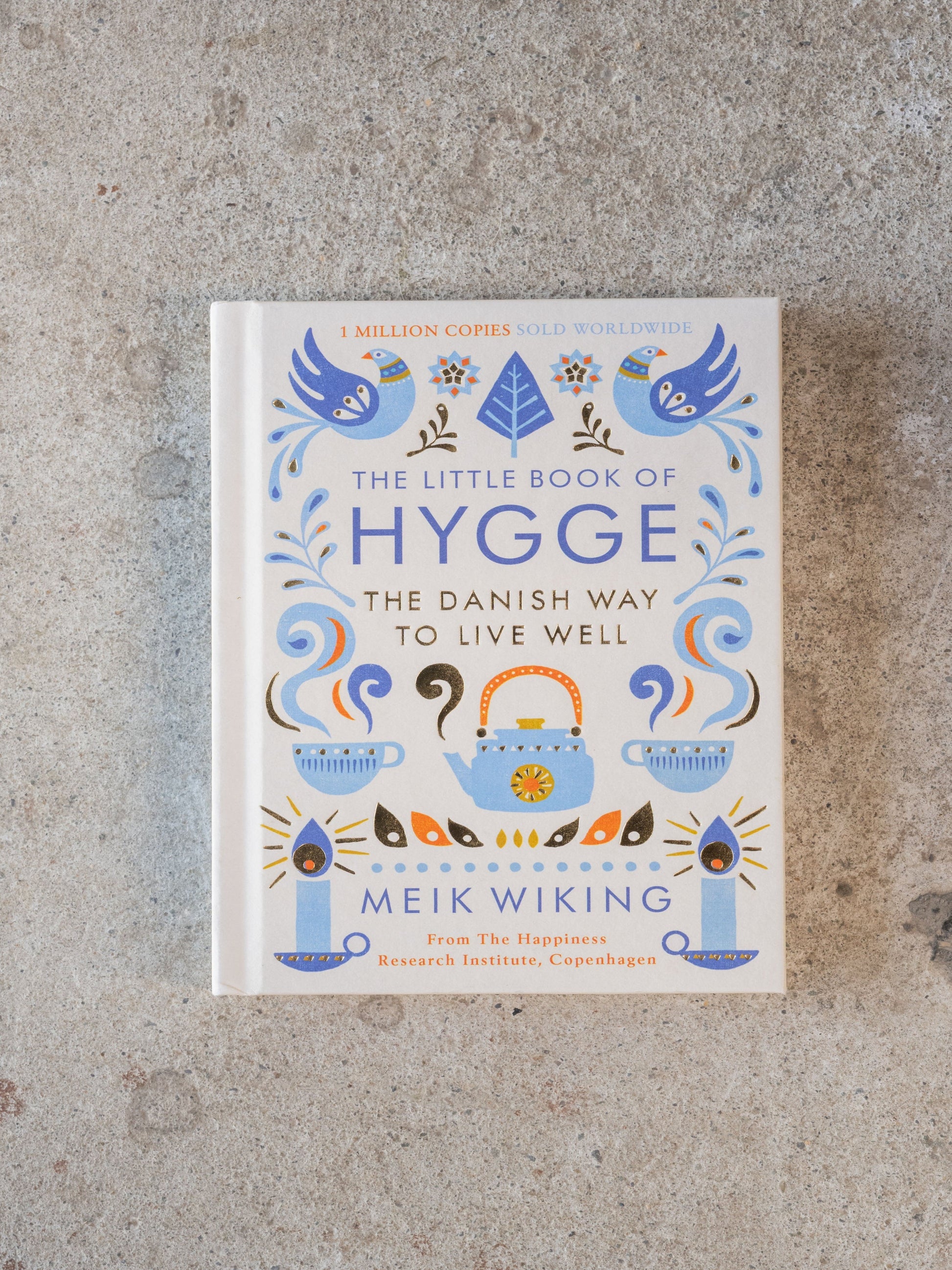 Book titled 'The Little Book of Hygge' on a textured surface