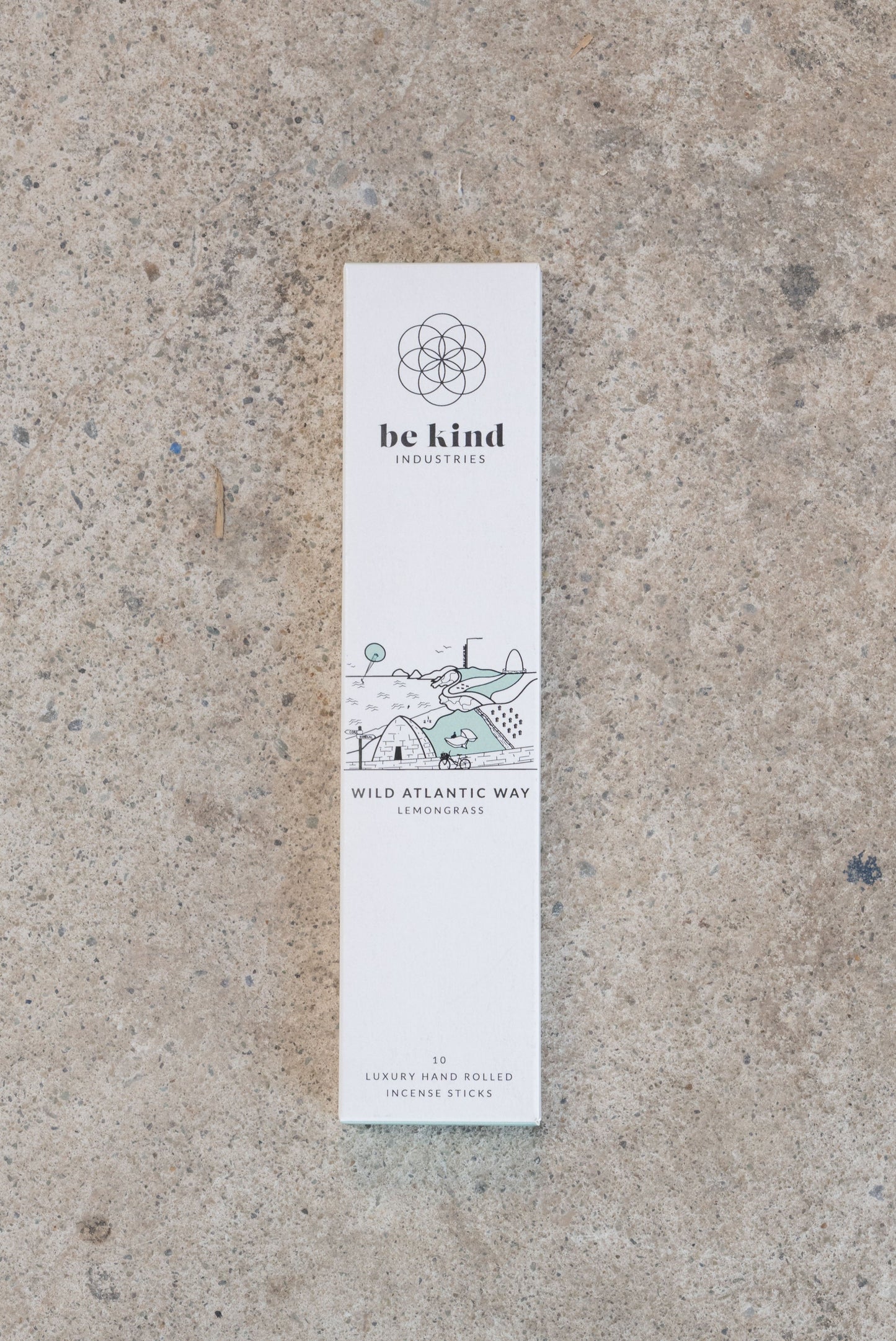 Be kind Industries Wild Atlantic Way incense stick packaging on a concrete surface. These are Lemongrass and depict an image of the wild Atlantic way. They contain 10 luxury hand rolled incense sticks.