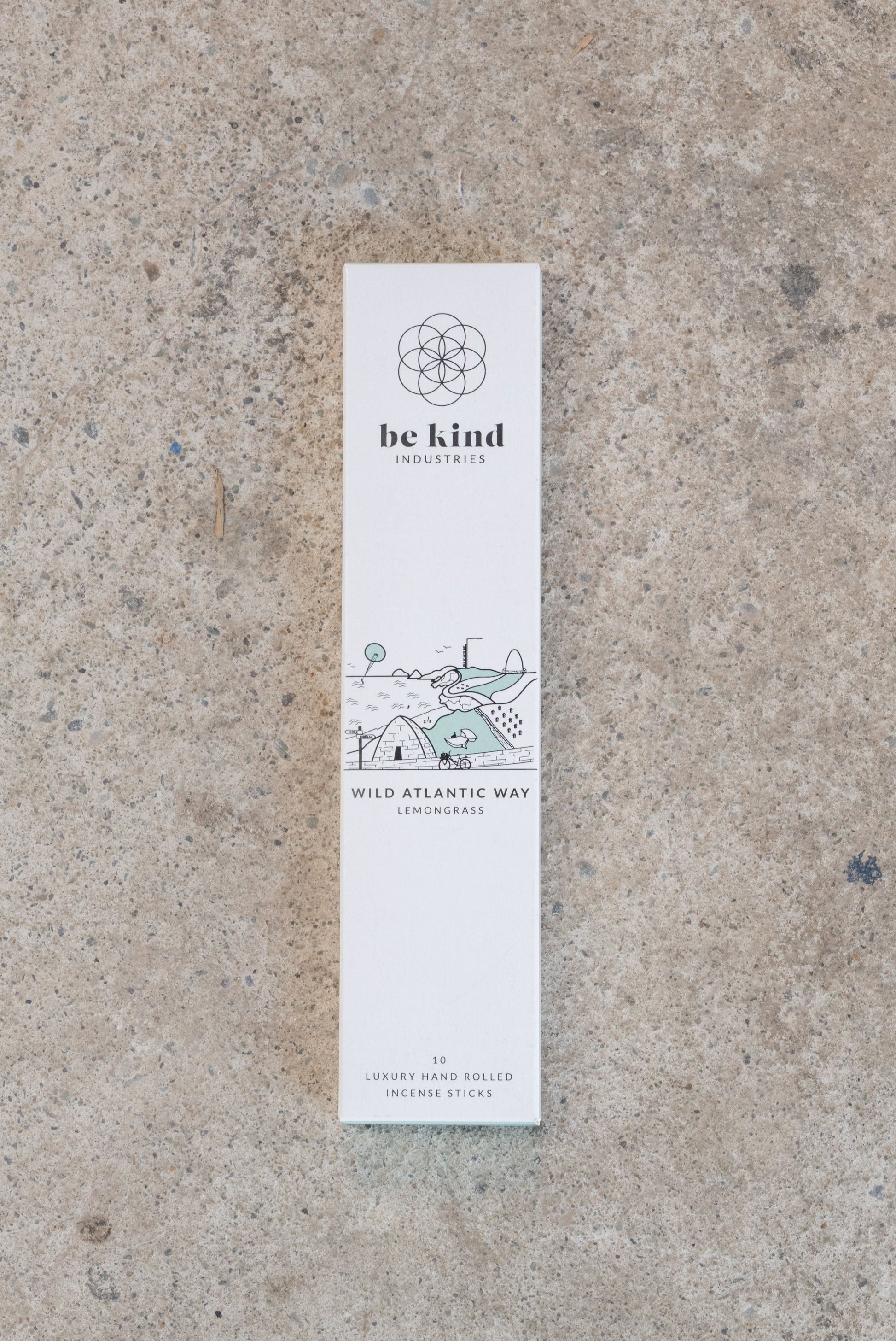 Be kind Industries Wild Atlantic Way incense stick packaging on a concrete surface. These are Lemongrass and depict an image of the wild Atlantic way. They contain 10 luxury hand rolled incense sticks.