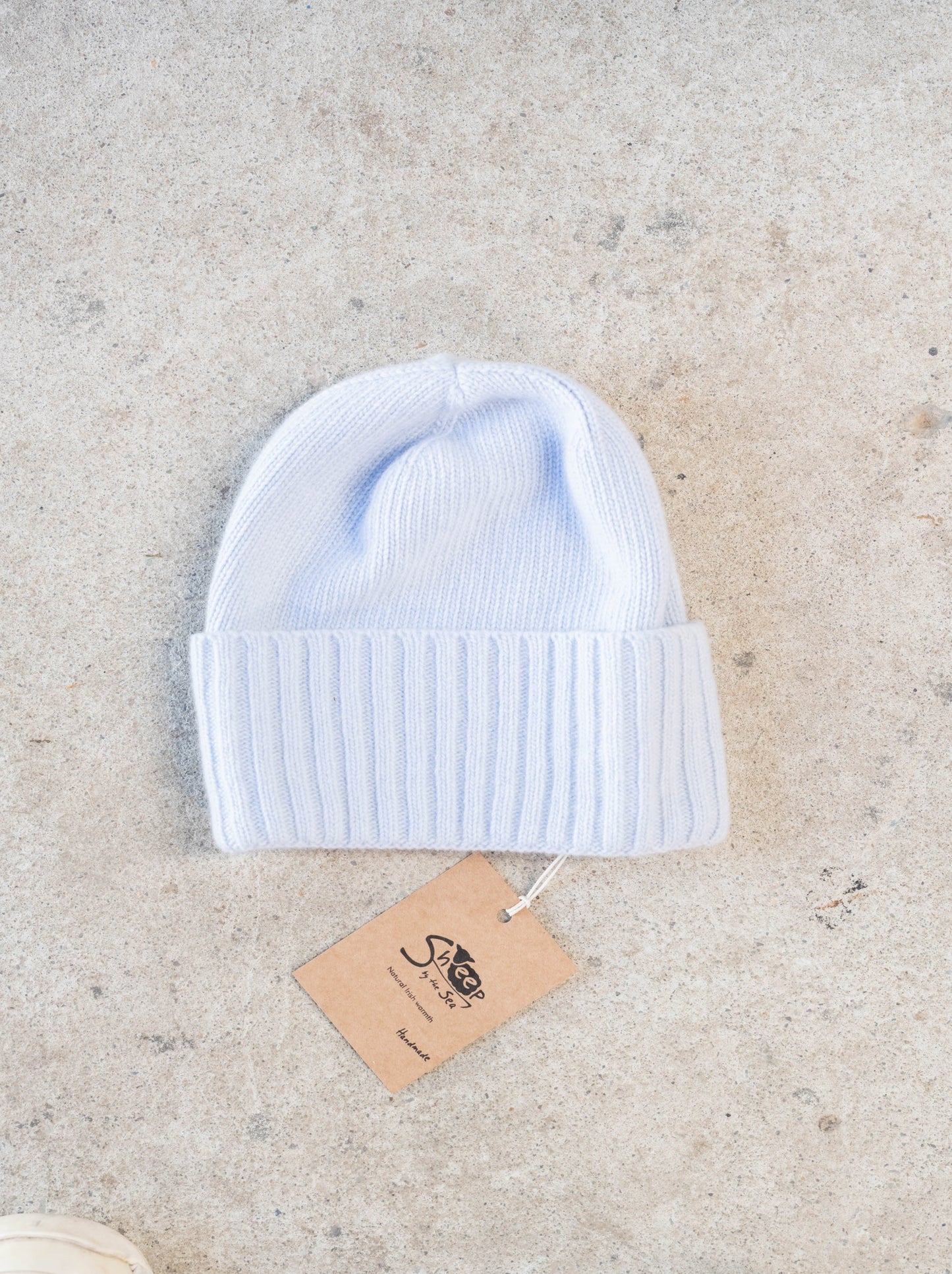 Light blue hat on a concrete surface.