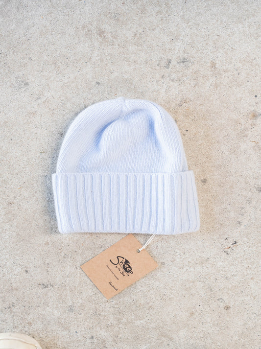 Light blue hat on a concrete surface.