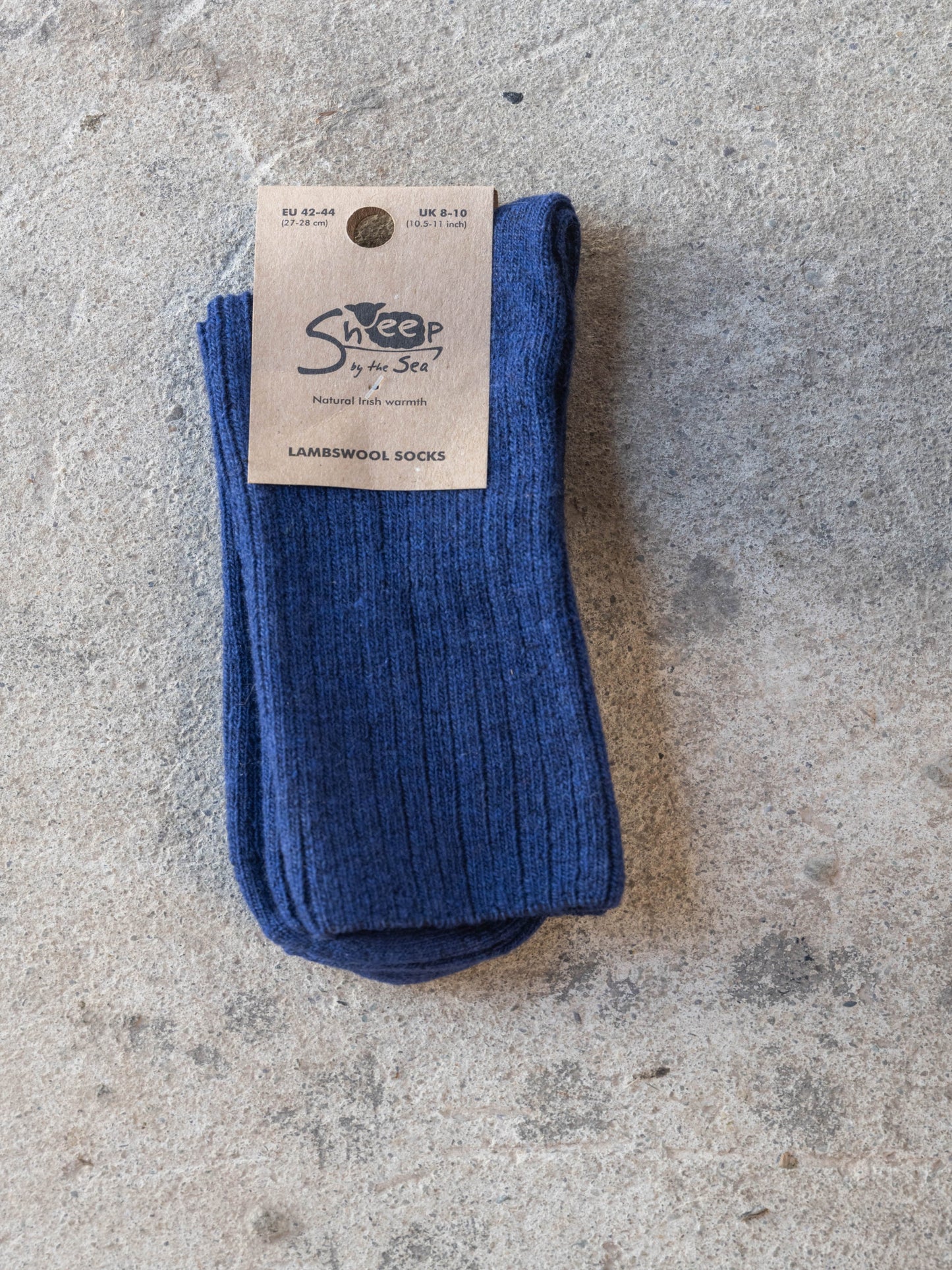 Blue socks with a label on a gray surface