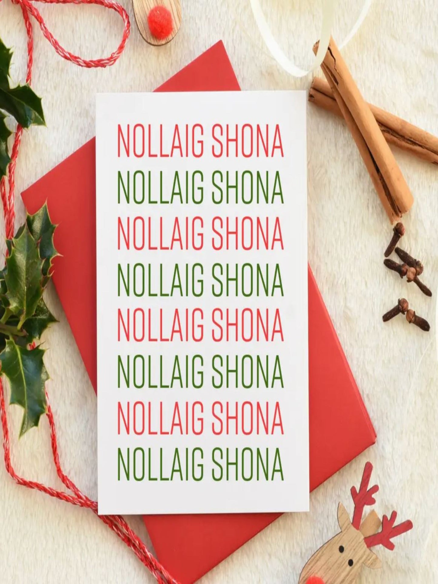 This card has the words Nollaig Shona that is written repeatedly across the card in red and green writing. The words read Nollaig Shona which is the gaelic for Happy Christmas.