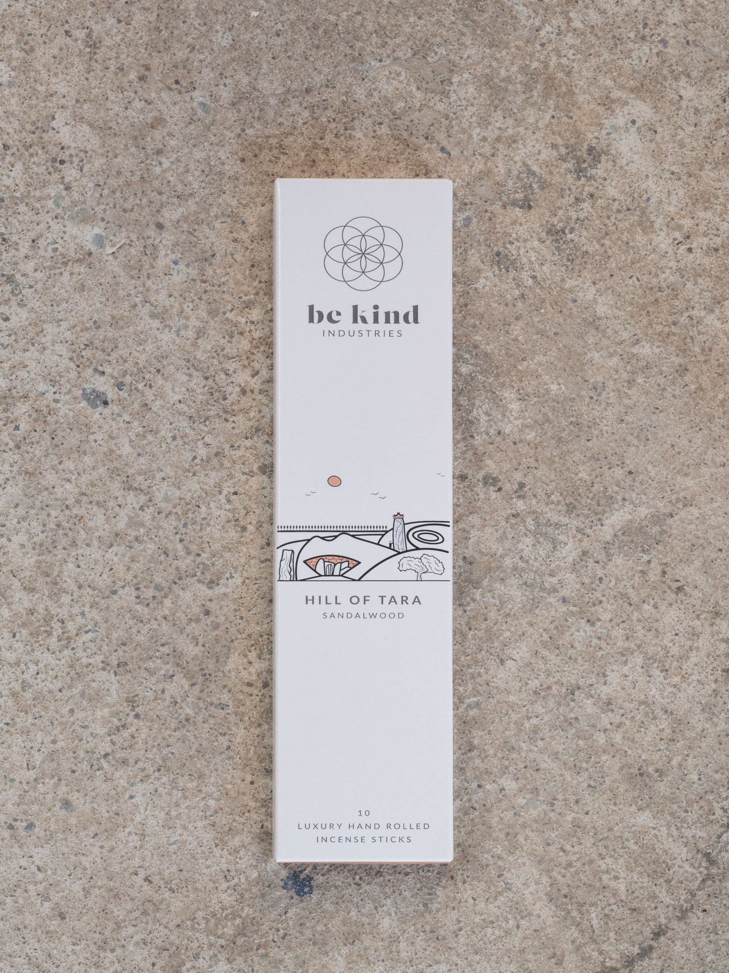 Incense stick packaging with 'be kind industries' branding on a textured surface. These are Sandalwood and the image on the front represents the Hill off Tara. They contain 10 luxury hand rolled incense sticks.