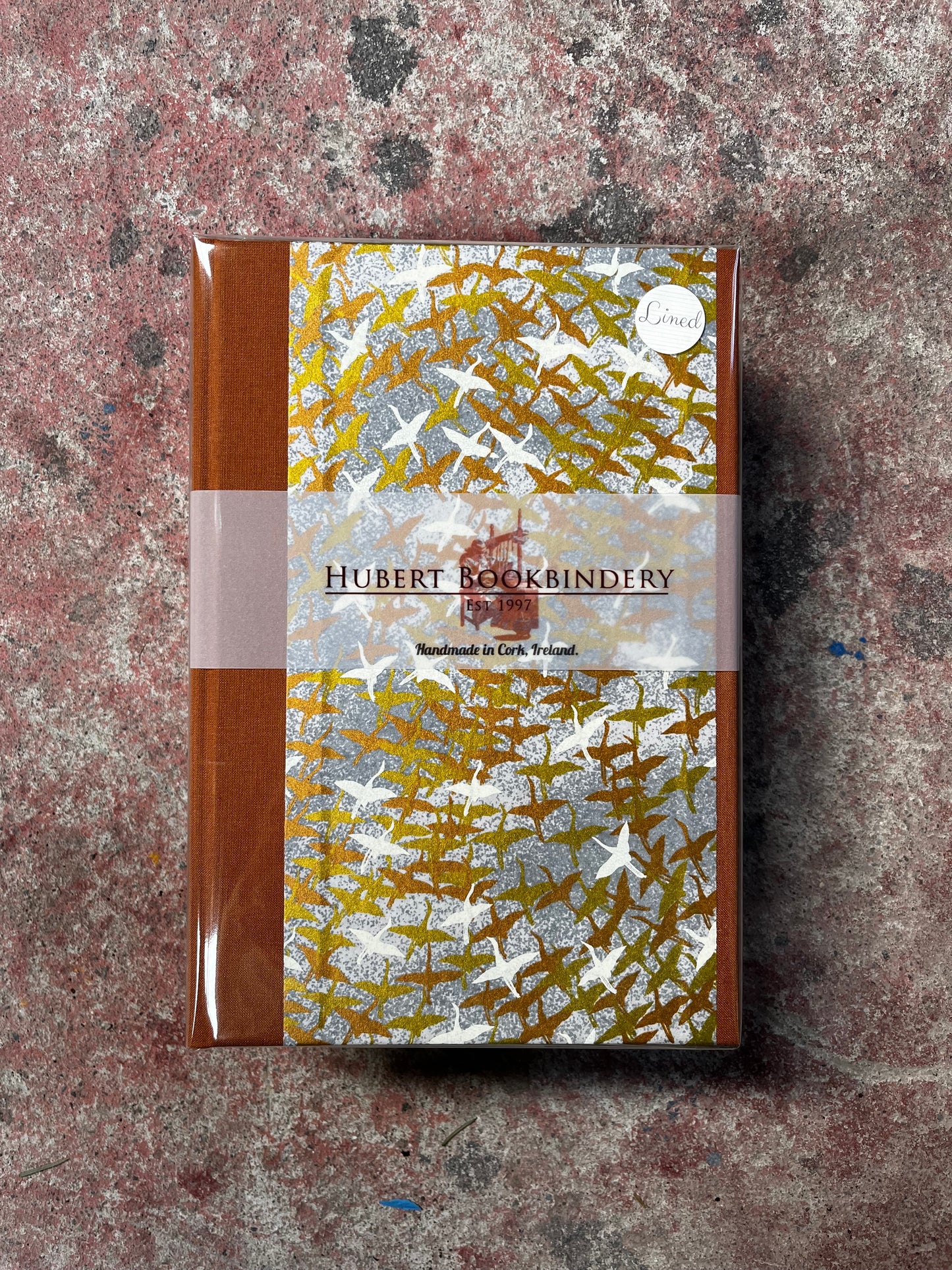 Notebook with decorative cover on a textured surface
