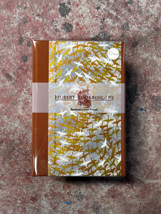 Notebook with decorative cover on a textured surface