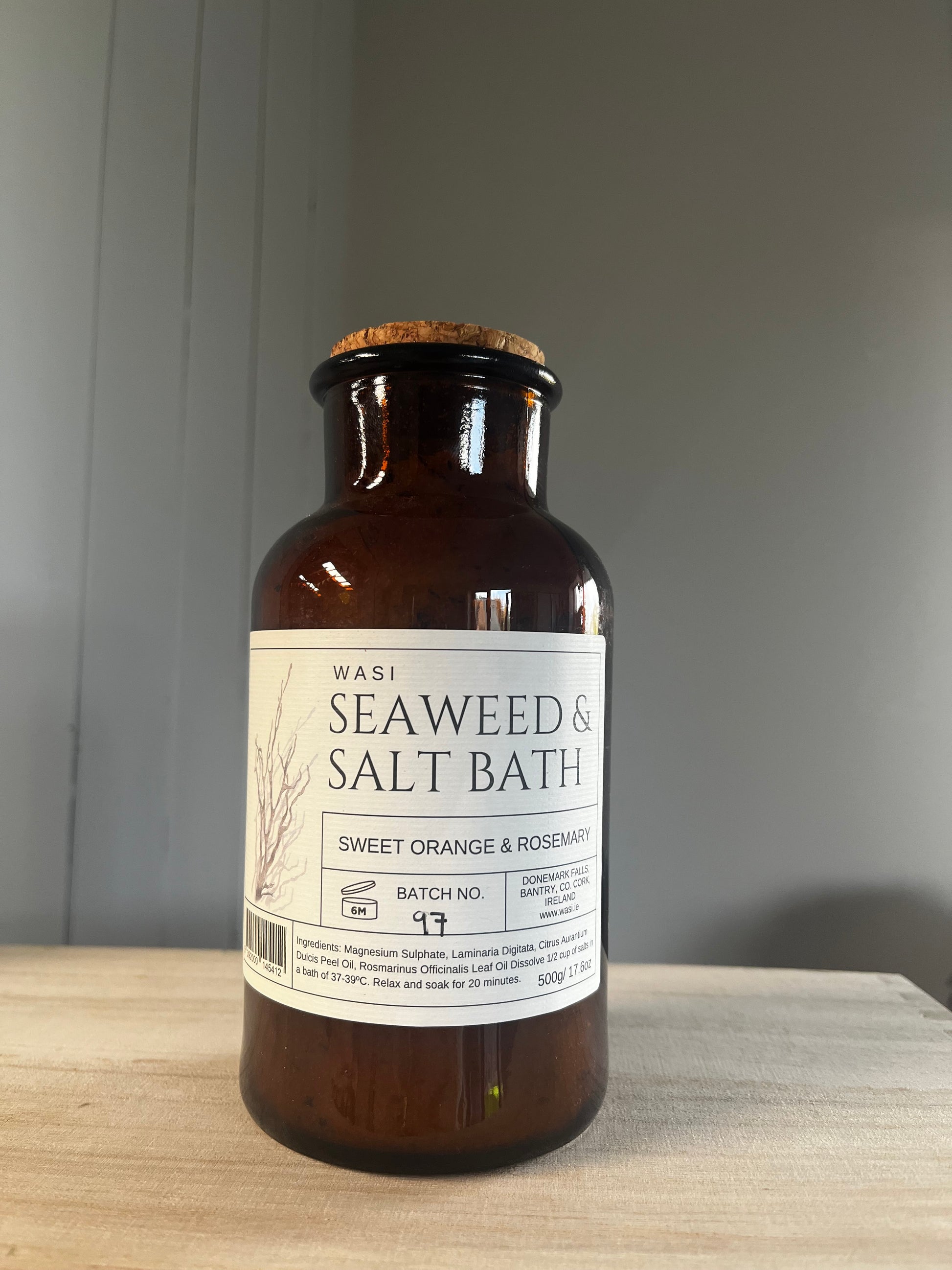 Brown bottle with a label on a wooden surface