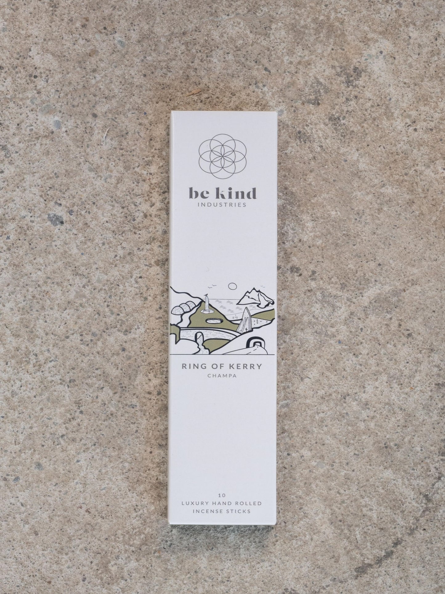This picture shows the package of luxury incense sticks. The box is white and narrow.  There are ten separate sticks in in the pack. These are called Ring of Kerry and they are Champa  flavoured. The box show the Be Kind logo and has a graphic image of the Ring of Kerry. 
